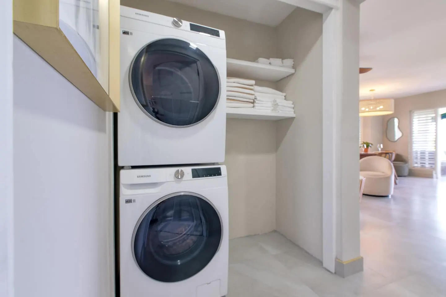 Laundry area with a stacked washer and dryer.