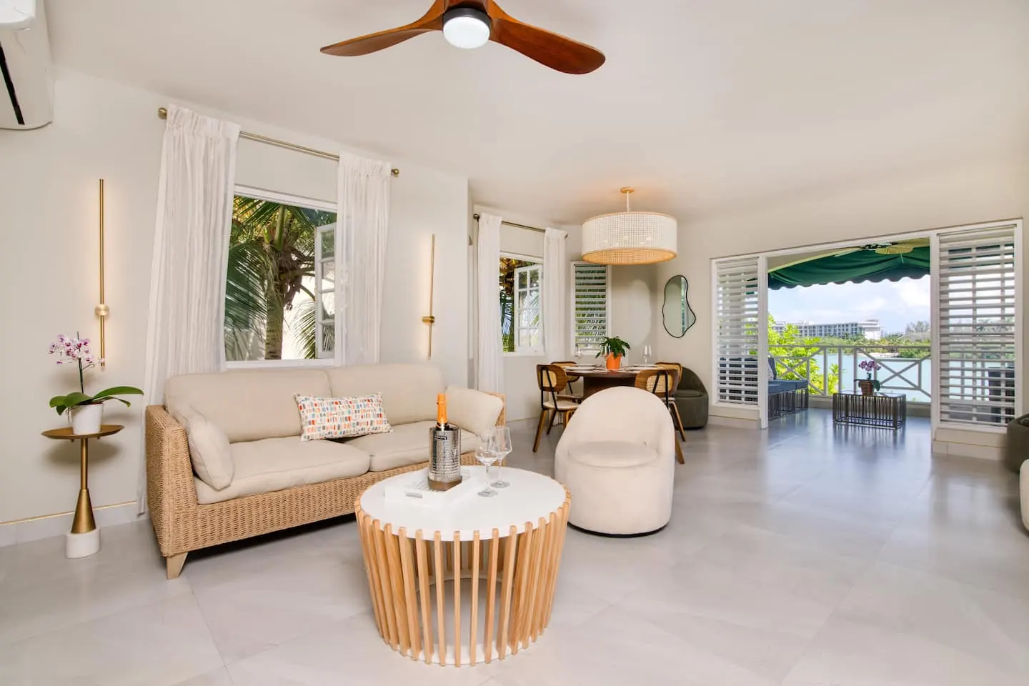 Open living and dining area with doors to the lagoon-facing balcony.