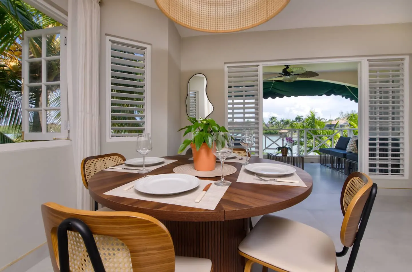 Dining table for four beside the balcony doors.